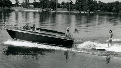 Correct Craft boat pulling paddle boarder